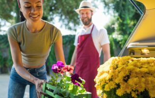 Florist loading flowers into vehicle for delivery