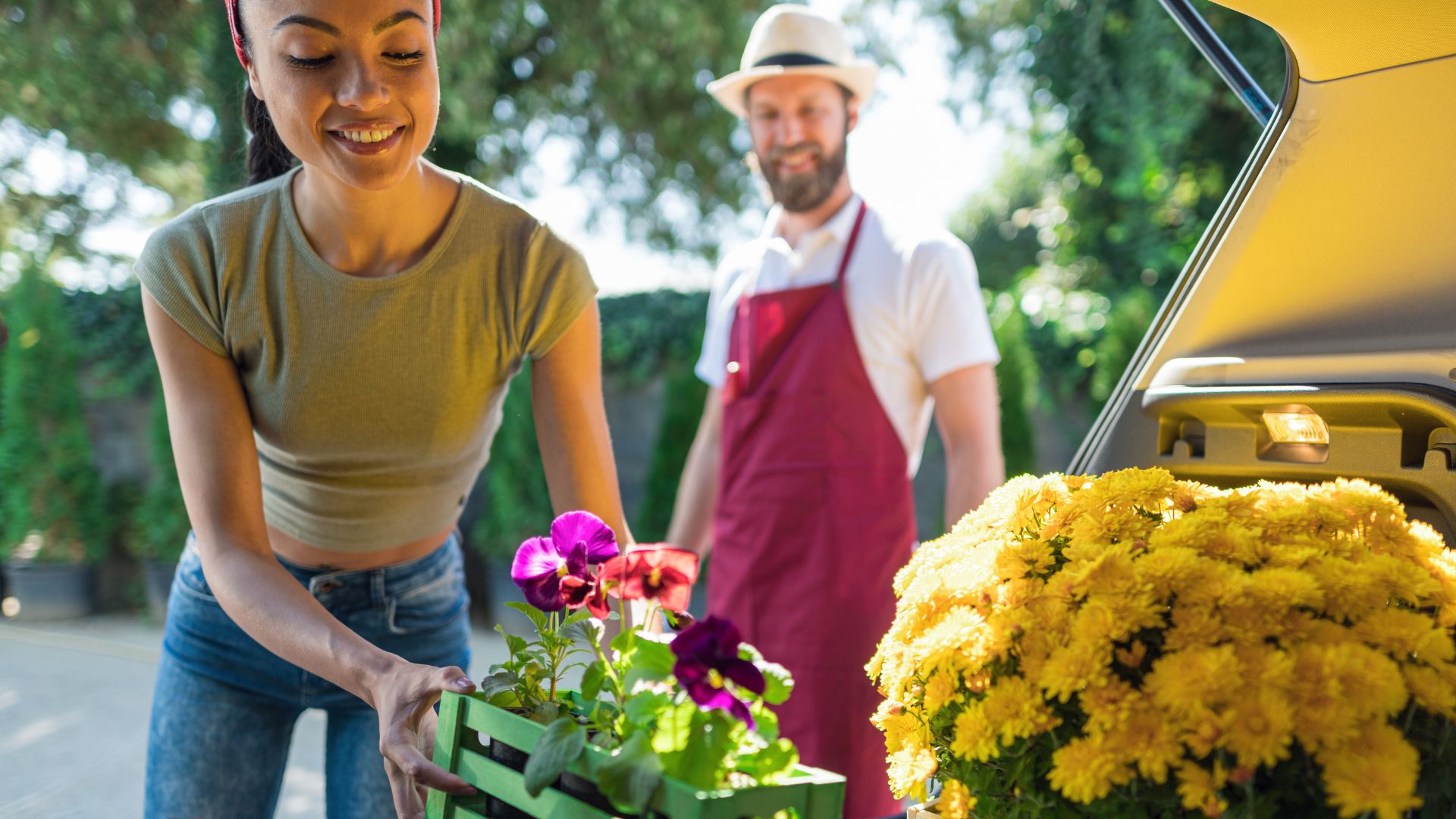 Florist loading flowers into vehicle for delivery