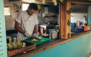 Food truck chef chopping vegetables